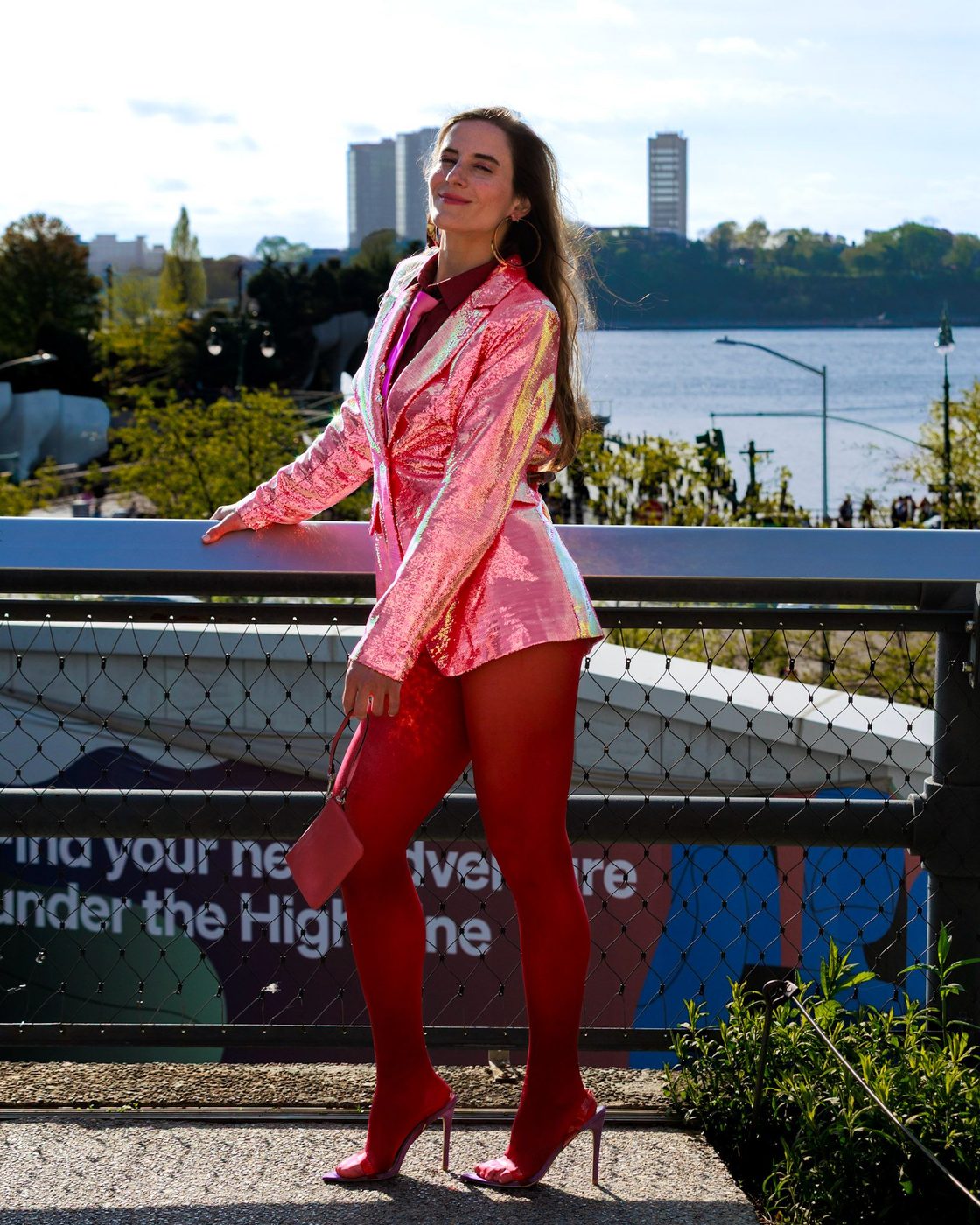 Gabriela in pink jacquard and scarlet tights against the Hudson on the High Line