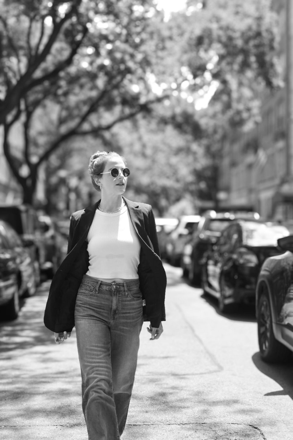 Black and white. Walking a tree lined street in a white tank, jeans and a black blazer.